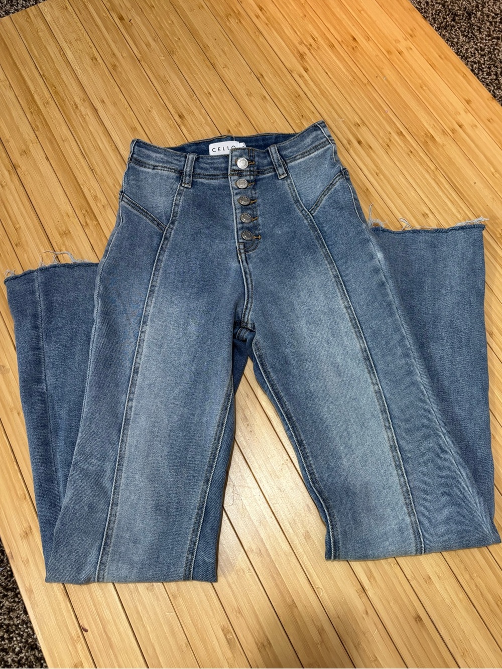 Cello flare leg with raw hem jeans. Button fly. Size 3.